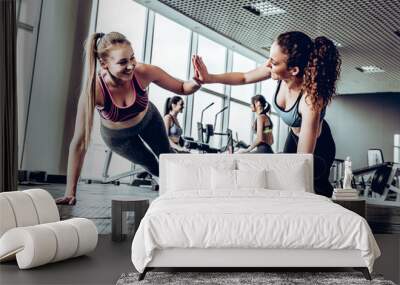 Two attractive fitness girls doing push ups Wall mural