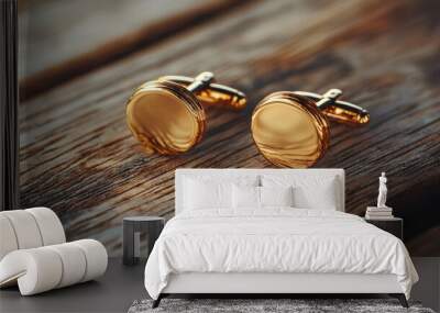 Classic gold cufflinks of the groom displayed on a polished wooden surface for elegant wedding accessories Wall mural