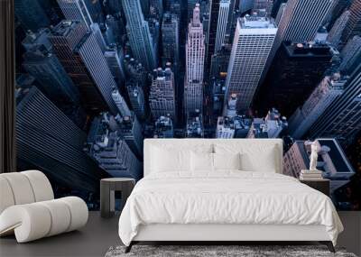 A striking aerial view of a bustling cityscape, showcasing towering skyscrapers and vibrant urban life below. Wall mural