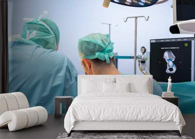 Team of doctor perform total hip arthroplasty replacement surgery in osteoarthritis patient inside the operating room. robot assisted robotic hip and knee replacement surgery	 Wall mural