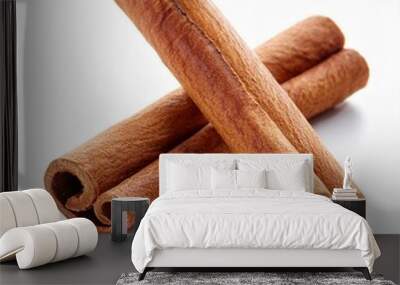 two cinnamon sticks isolated on white background Wall mural