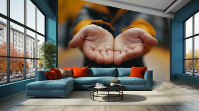 A person holding their hands out in front of them with an open palm ready to receive something Wall mural