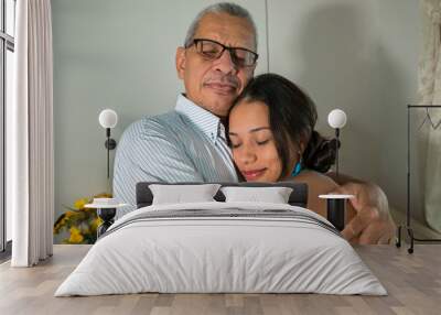 Latin Young daughter hugs her father Wall mural