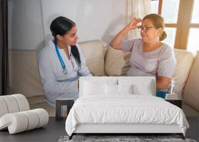 Older Hispanic woman and doctor in a medical office Wall mural