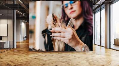 Beautiful young woman getting her haircut by a hairstylist at a beauty salon. Wall mural