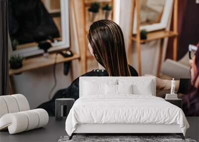 Beautiful young woman preparing for haircut at a beauty salon. Wall mural