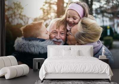 Grandparents having fun with their grandchildren in city park. Wall mural