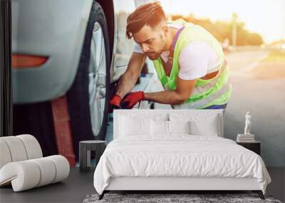 Handsome middle age man working in towing service on the road. Roadside assistance concept. Wall mural