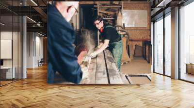 Two master carpenters working together in their woodwork or workshop.  Wall mural