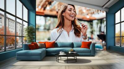 Young beautiful and happy woman enjoying in delicious meal in luxurious restaurant. Wall mural