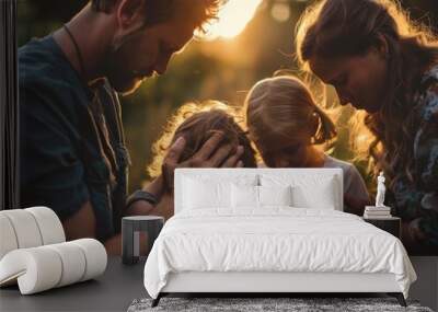 A family prays together during sunset in a lush garden, creating a moment of reflection and togetherness Wall mural