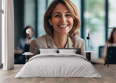 Confident businesswoman smiling during a team meeting in a modern office setting Wall mural