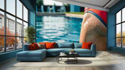 Low angle rear view of a wet male swimmer in speedo in a pool  Wall mural