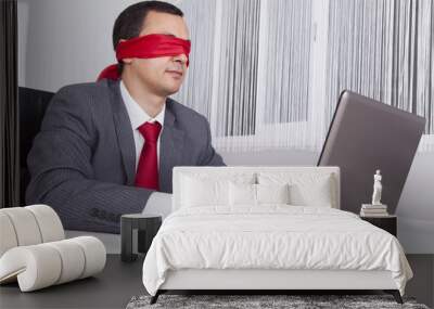 blindfold businessman working with his laptop Wall mural