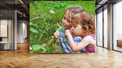 Little girls smelling flowers Wall mural