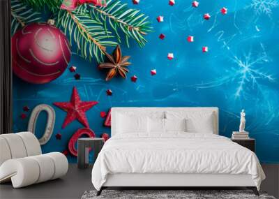 Colorful holiday decorations adorn a blue background with red ornaments, pine branches, and glittering elements celebrating the festive season and marking the year 2005 Wall mural