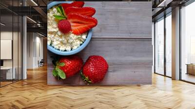 Fresh farm cottage cheese with strawberries-a great Breakfast for those who care about health. Two blue bowls of cottage cheese are on a wooden table. Selective focus. Copy space.  The view from the t Wall mural