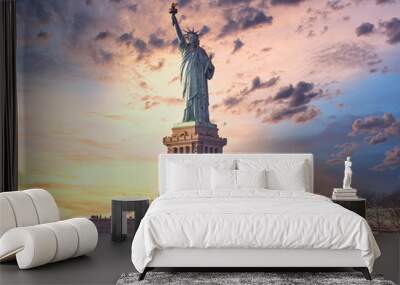 famous statue of  liberty and dramatic sky at sunset with orange colors. Travel concept Wall mural