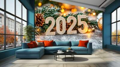 fondo navideño con 2025 hecho de madera encima de un mostrador con nieve artificial y decorado con bolas, piñas y ramas de abeto sobre fondo desenfoncado dorado Wall mural