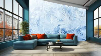 Intricate frost and snowflake patterns on a blue icy background Wall mural