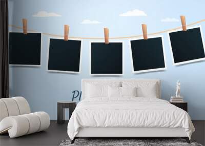 Blank set photo picture frames on blue sky background. Retro snapshots, instant photos mockup hanging on a thread. Banner with place for text. Photo template. Vector illustration Wall mural