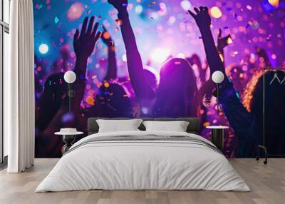 Dynamic scene of people dancing and celebrating at a party or club with confetti in the air and colorful lights in the background. Wall mural