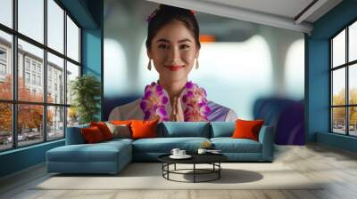 asian stewardess woman in a purple and white traditional dress smiles and greets with her hands clas Wall mural