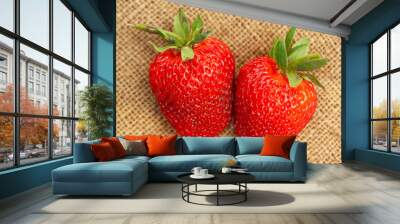 Two bright juicy strawberries on a sacking. Wall mural