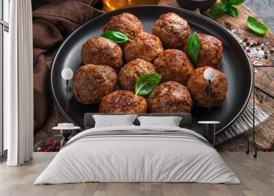 Meatballs with fresh basil on a wooden board. Wall mural