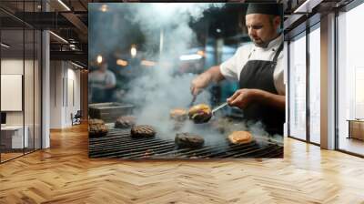 Chef grilling burgers in a busy restaurant kitchen with smoke and flames Wall mural