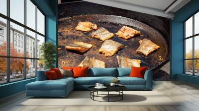 Grilled salmon fillets cooking in large pan on outdoor stove with golden crust, summer barbecue concept Wall mural