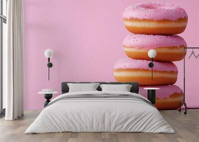 Stack of pink frosted donuts with sprinkles on pastel background Wall mural