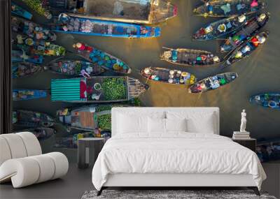 AERIAL: Local people buying and selling colorful produce from wooden boats. Wall mural