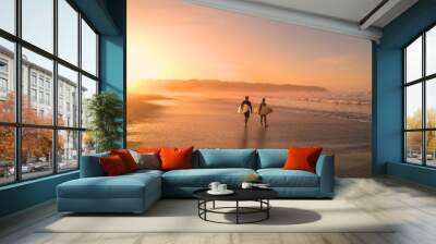 AERIAL: Young couple walking on beautiful sandy beach after sunset surf session Wall mural