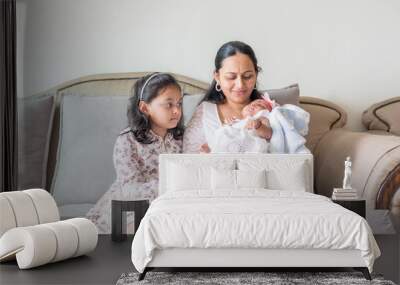 ndian family spending time together, wearing traditional and casual outfits with a baby, a young girl, and grandparents in a high-rise apartment in Kuala Lumpur, Malaysia. Wall mural