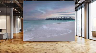 Landscape of huts over the sea under a cloudy sky in the evening Wall mural