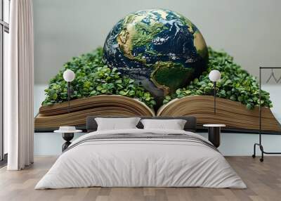 A globe resting on an open book with green sprouts growing from the pages, symbolizing the importance of learning and sustainability for the planet. Wall mural