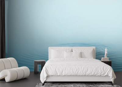 A lone seal surfaces in calm, blue water, creating ripples. Wall mural