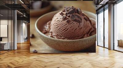 A scoop of rich chocolate ice cream topped with chocolate chips in a brown bowl. Wall mural