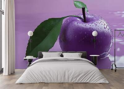 A single, purple apple with green leaves sits on a purple surface with water droplets. Wall mural