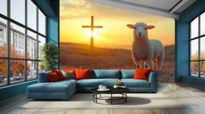 A white lamb stands in a field at sunset with a wooden cross in the background. Wall mural