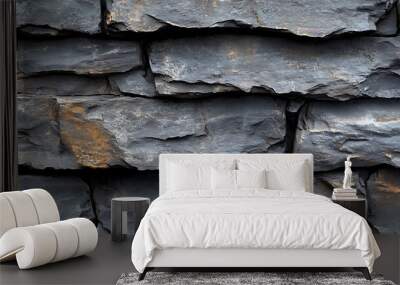 Close-up of a dark gray stone wall with a rough texture. Wall mural