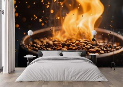 Close-up of roasted coffee beans in a bowl with flames and sparks. Wall mural