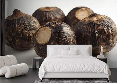 Five brown, round, peeled taro root bulbs on a white surface. Wall mural