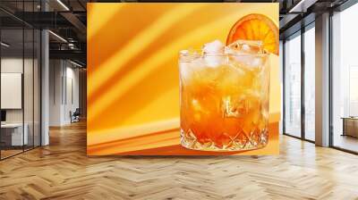 Iced orange drink with ice cubes in a glass. Wall mural