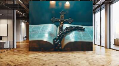 Open bible with crucifix and rosary beads, illuminated by candles. Wall mural