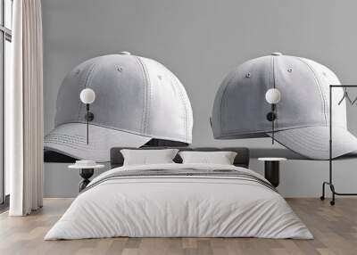 Two white baseball caps on a grey background. Wall mural