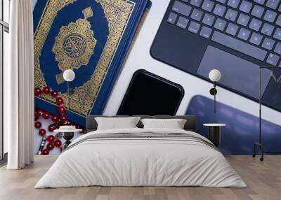 The application of technology devices and applications into digitization of Quran, or e-Quran. Online learning, or Quran recital using apps. Arabic words on the book means Holy Quran Wall mural