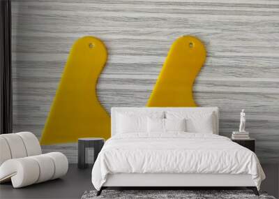 A pair of yellow paint scrapers which are very useful for smoothing cement, smoothing grout lines and covering cracks in isolated walls with a white wood pattern Wall mural