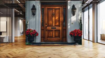 A classic wooden front door with two potted plants on either side.  The door is a rich brown color, and the plants are in bloom. Wall mural